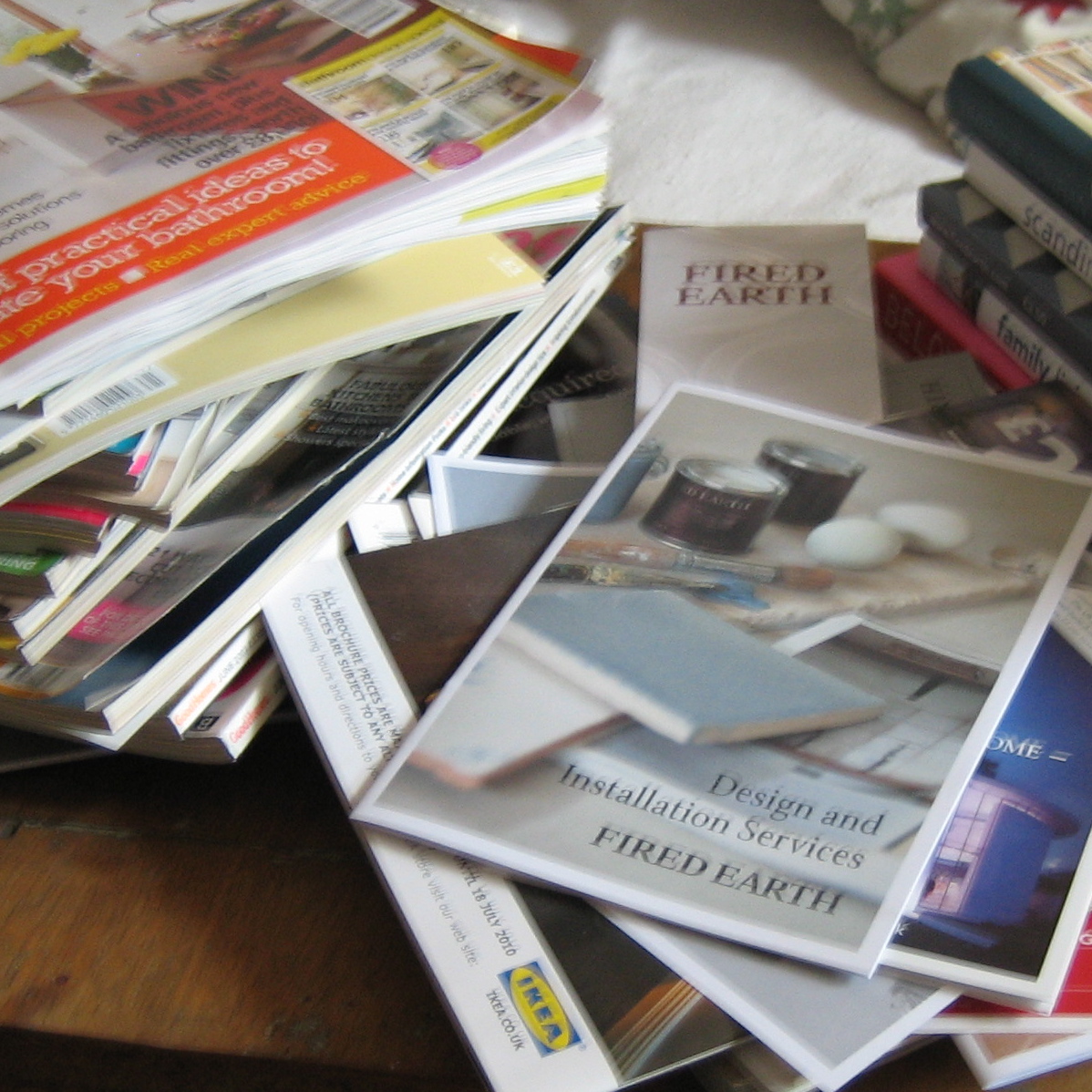 Coffee table overflowing with interior design books and magazines